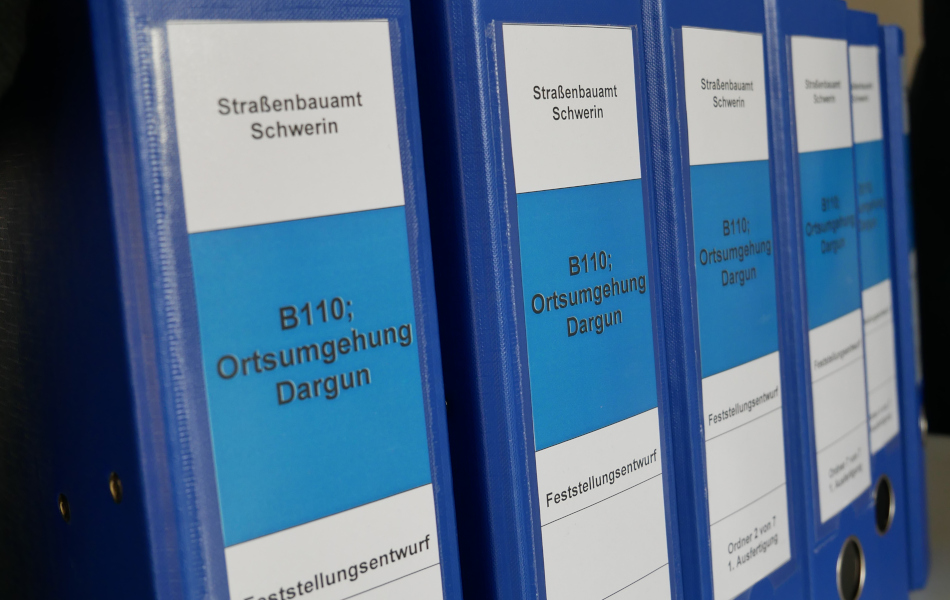 Die Ordner für das Planfeststellungsverfahren zur Ortsumgehung Dargun/B110 stehen nebeneinander aufgereiht.