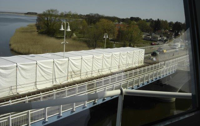 Auf einer Brücke steht ein langgezogenes Zelt.