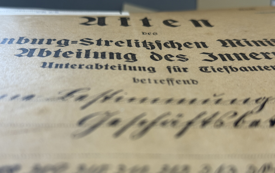Close-up of a historic German document featuring printed Fraktur script and handwritten annotations.